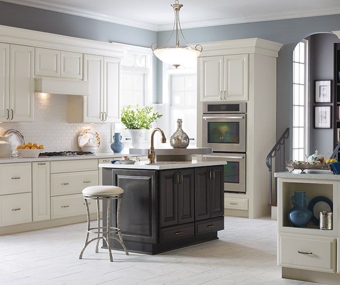 Sullivan off white kitchen cabinets in Coconut with a dark grey kitchen island in Storm